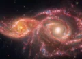 The image of two glaring eye-like eerie galaxies continues