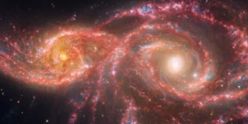 The image of two glaring eye-like eerie galaxies continues